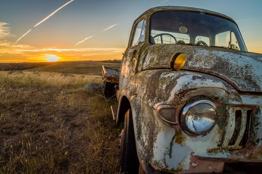 Abandoned Wreck Car In A Field In Australia At Sunset