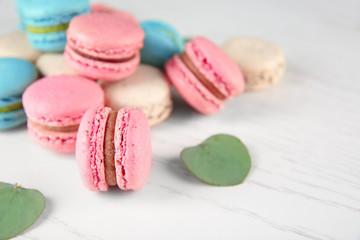 Tasty macarons on light background
