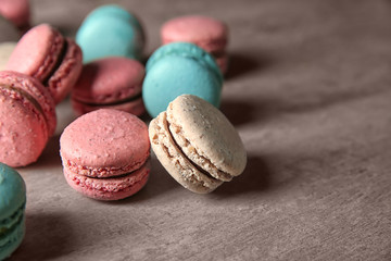Tasty macarons on color background