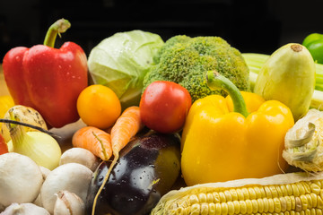 Close-up image of fresh organic vegetables. Locally grown bell pepper, corn, carrot, mushrooms and other natural vegan food.