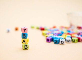 Baby : Colorful cube letters on orange Background