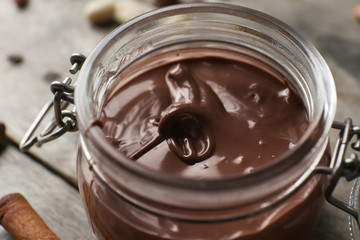 Jar with molten chocolate, closeup