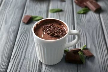 Fotobehang Cup with molten chocolate on wooden table © Pixel-Shot
