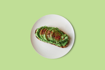 Delicious and nutritious veggie toast or sandwich with avocado and guacamole in a minimal style. Healthy food. A useful snack