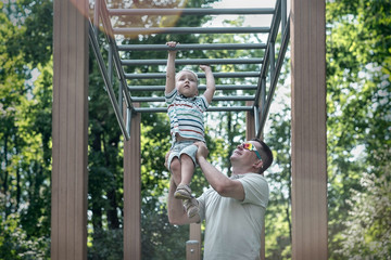 Obraz premium Father and son exercising outdoor.