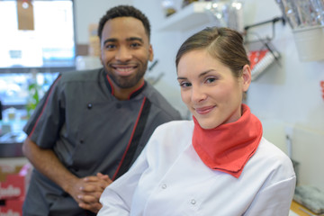 male and female butchers in store