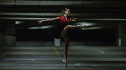 Portrait of ballet dancer on pointe in an underground car park
