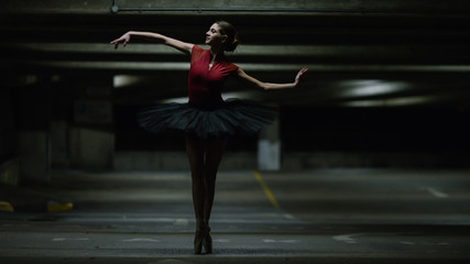 Portrait of ballet dancer dancing in an underground car park