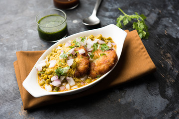 Ragda Pattice is a popular Street food or chat made of potato Patties. served in a steel plate, bowl or ceramic plate with tamarind and cilantro chutney