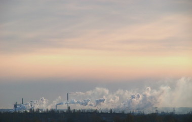 Naklejka na ściany i meble Sunset landscape with industrial smoke