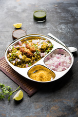 Ragda Pattice is a popular Street food or chat made of potato Patties. served in a steel plate, bowl or ceramic plate with tamarind and cilantro chutney