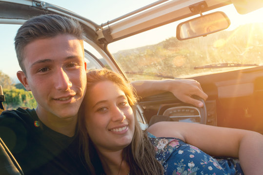 Couple in a car at sunset