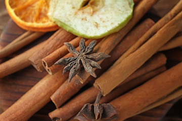 Cinnamon sticks and anise stars on table, closeup