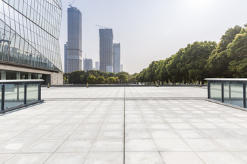 Fototapeta premium Panoramic skyline and modern business office buildings with empty road,empty concrete square floor