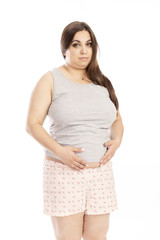 Fototapeta premium Thick young woman sad, isolated on white background