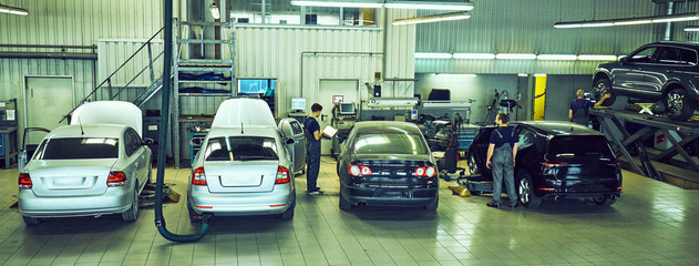 Obraz premium Auto mechanic with tool working check and fixed an old car engine at service station