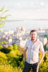 Portrait of a man in the background of Saratov, Russia, view of the houses, the Volga River, the bridge to Engels. The landscape of the city from a height.