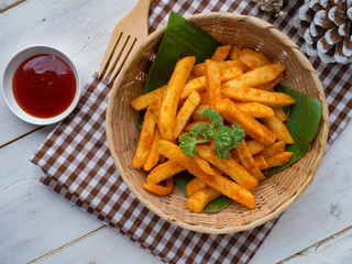 French fried barbeque flavour in wood basket on white wood table.