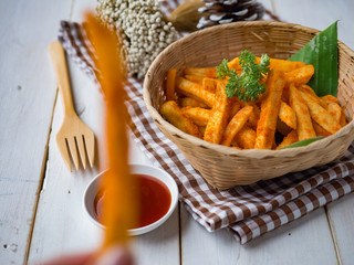 French fried barbeque flavour in wood basket on white wood table.