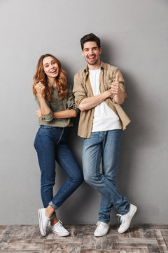 Full length portrait of a cheerful young couple standing