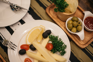 Cheese plates served with tomato and 
olive.