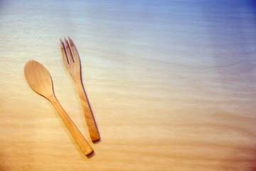 Fork and spoon lay on the wooden table, Utensil on the wooden table, with dreamy color