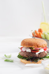 Veggie bean and quinoa burger with fresh vegetables