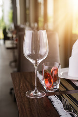 Reserved sign on a table in restaurant. Empty glasses set in restaurant