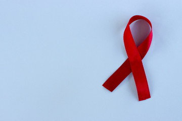 Red ribbon on a blue background, medical concept, HIV, AIDS
