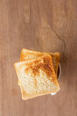 Sliced Toast Bread on wood background, top view