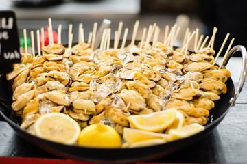 A plate with seafood mussels with lemon sauce on the wooden table