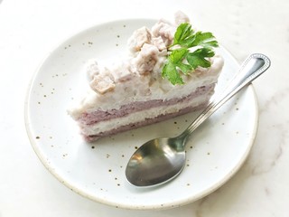 Taro cake mixed with coconut on white plate 