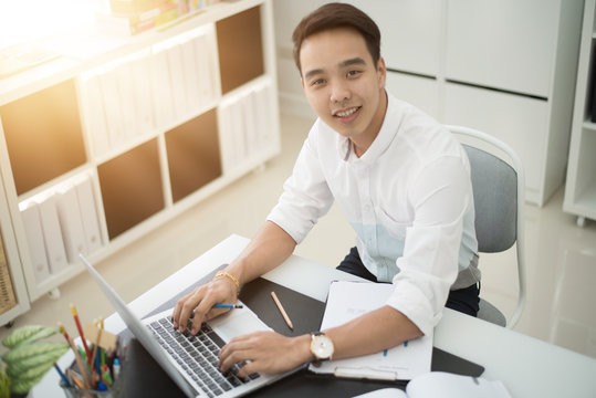 Asian young businessman working at his office.