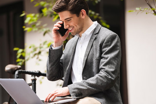 Happy young businessman dressed in suit