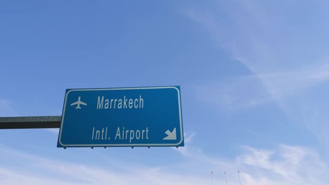 marrakech airport sign airplane passing overhead