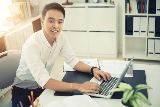Asian young businessman working at his office.