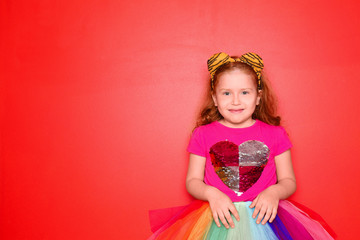 Cute little girl wearing festive clothes on color background. Birthday celebration