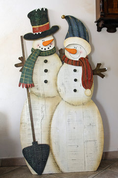 colorful pastel silhouette of snowman with scarf and hat and wife