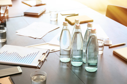 Table With Bottles Of Water Prepared For Business Meeting In Conference Hall