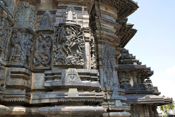 Fototapeta na wymiar Ornate wall panel reliefs depicting, from left, Sundari, Nagas, Shiva as Gajasurasamhara, Bramha and Narayana on the extre right. Chennakesava temple, Belur, Karnataka. View from West.