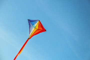 Colorful kite flying in blue sky