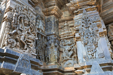 Ornate wall panel reliefs depicting, from left, Narsimha, Sundari, Nagas, Vishnu as Varaha and Lord Bramha Chennakesava temple, Belur, Karnataka. View from West.