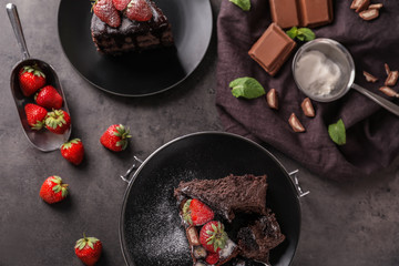 Delicious chocolate cake with berries on grey table