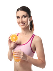 Woman with glass of fresh juice and half of orange on white background