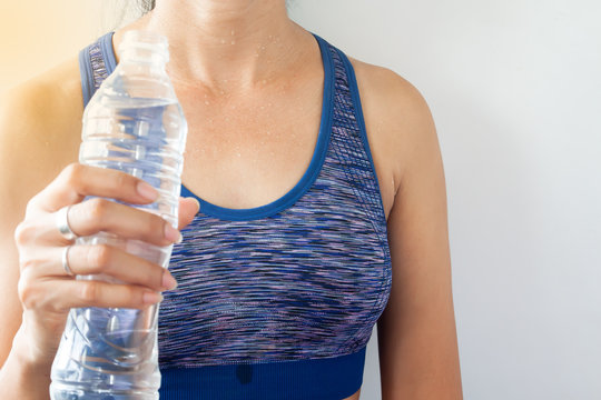 Tan skin asian woman with sweat, Healthy workout woman holding bottle of water