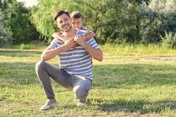 Father and son in park on summer day