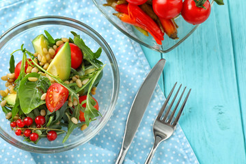 Glass bowl with tasty vegetable salad on table
