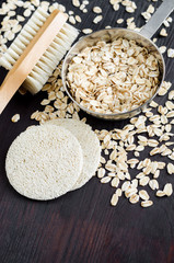 Rolled oats in a small bowl for preparing homemade facial mask and scrub. DIY oatmeal cosmetics. 