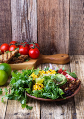 Bowl with abocado and colorful vegetables, healthy vegan meal