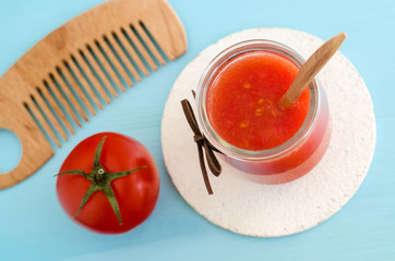 Tomato puree in a glass jar and olive oil for preparing homemade face and hair mask. Ingredients of DIY cosmetics. Top view, copy space.